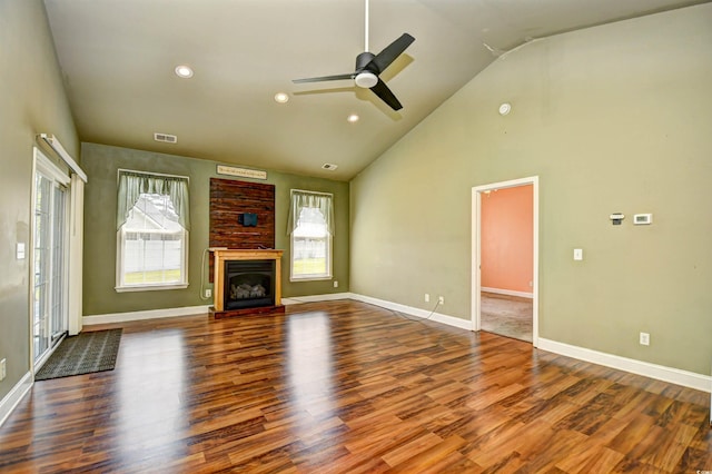 1412 Reid Ct, Myrtle Beach, SC 29588 - unfurnished living room with healthy amount of natural light, ceiling fan, wood finished floors, high vaulted ceiling, and a fireplace with raised hearth