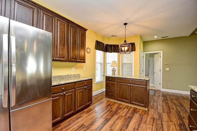 1412 Reid Ct, Myrtle Beach, SC 29588 - kitchen with freestanding refrigerator, baseboards, dark wood-style flooring, a center island, and hanging light fixtures