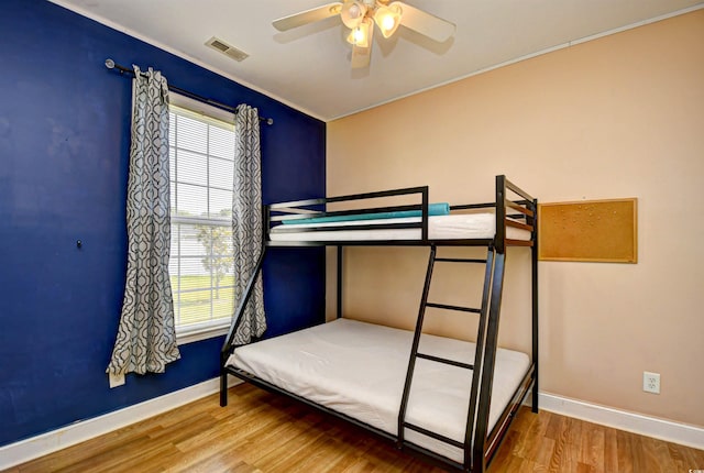 1412 Reid Ct, Myrtle Beach, SC 29588 - bedroom with baseboards, wood finished floors, ornamental molding, and a ceiling fan