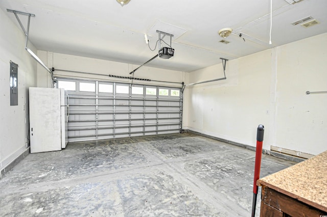 1412 Reid Ct, Myrtle Beach, SC 29588 - garage featuring freestanding refrigerator, a garage door opener, electric panel, and baseboards