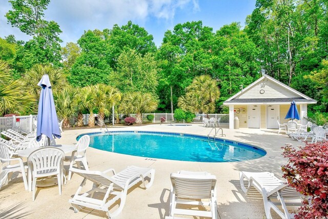 1412 Reid Ct, Myrtle Beach, SC 29588 - community pool with view of wooded area and a patio area