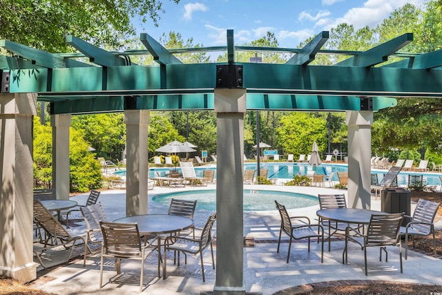 1221 Tidewater Dr Unit 122, North Myrtle Beach, SC 29582 - view of patio featuring a pergola and a community pool