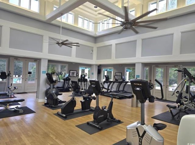 1221 Tidewater Dr Unit 122, North Myrtle Beach, SC 29582 - exercise room featuring french doors, a towering ceiling, ceiling fan, and wood finished floors