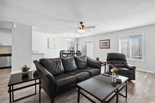 800 9th Ave S Unit E-4, North Myrtle Beach, SC 29582 - living room with wood finished floors, ceiling fan, plenty of natural light, a textured ceiling, and a chandelier