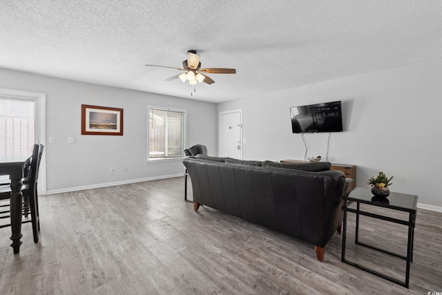 800 9th Ave S Unit E-4, North Myrtle Beach, SC 29582 - living area with a ceiling fan, a textured ceiling, and wood finished floors