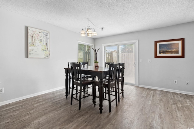 800 9th Ave S Unit E-4, North Myrtle Beach, SC 29582 - dining space with wood finished floors, a chandelier, and a textured ceiling