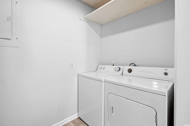 800 9th Ave S Unit E-4, North Myrtle Beach, SC 29582 - laundry area featuring washer and dryer, electric panel, and light wood-type flooring