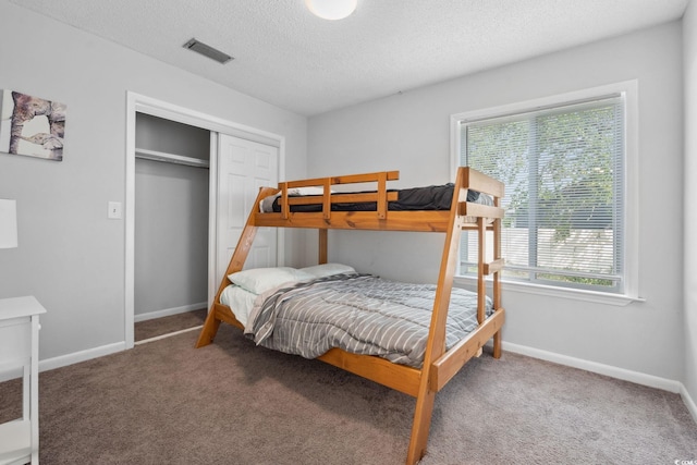 800 9th Ave S Unit E-4, North Myrtle Beach, SC 29582 - carpeted bedroom featuring a closet and a textured ceiling