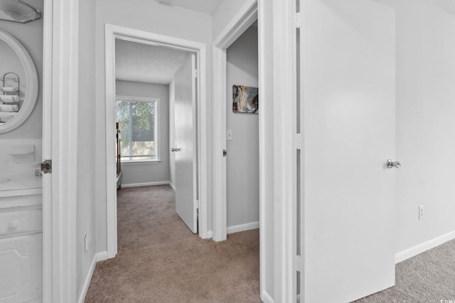 800 9th Ave S Unit E-4, North Myrtle Beach, SC 29582 - corridor featuring carpet floors and a textured ceiling