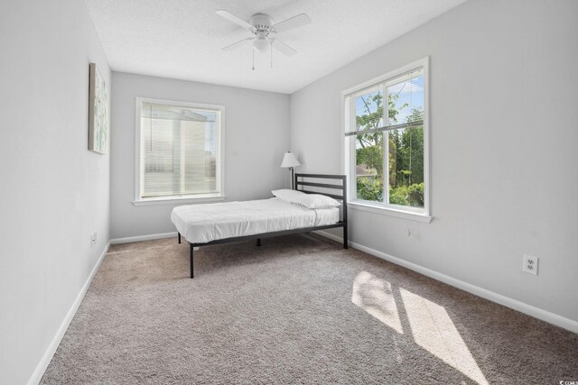 800 9th Ave S Unit E-4, North Myrtle Beach, SC 29582 - bedroom featuring carpet flooring, a ceiling fan, and a textured ceiling