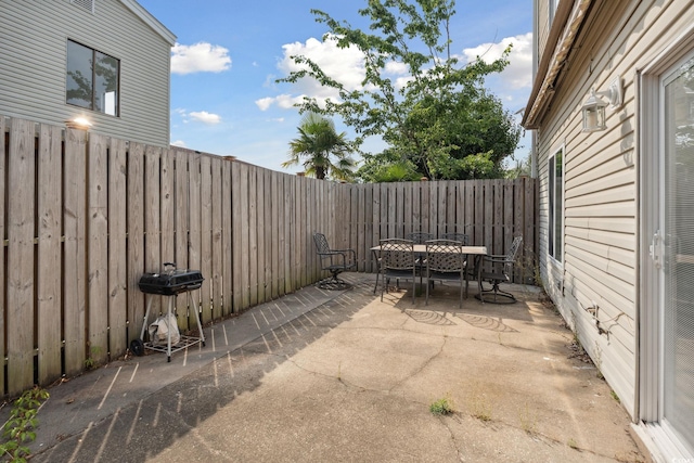 800 9th Ave S Unit E-4, North Myrtle Beach, SC 29582 - fenced backyard with outdoor dining area, a patio, and a grill
