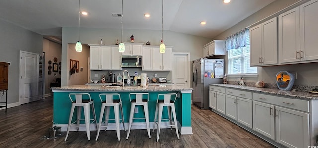 784 Flowering Branch Ave, Little River, SC 29566 - kitchen with appliances with stainless steel finishes, vaulted ceiling, dark wood-style floors, a breakfast bar, and an island with sink