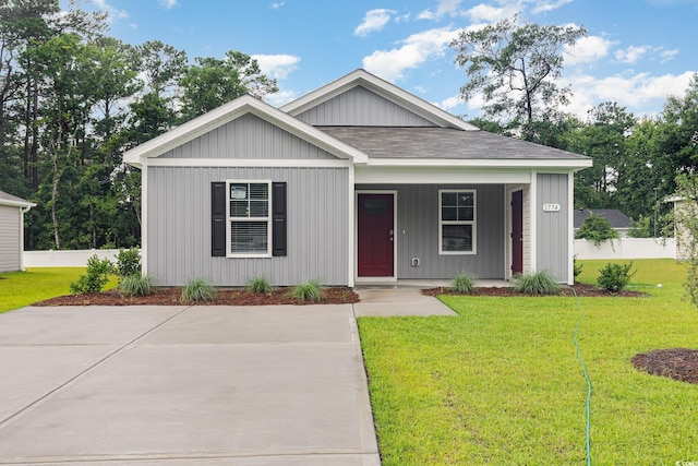 1710 Whispering Pine St, Ocean Isle Beach, NC 28469 - view of front of house featuring covered porch, a shingled roof, and board and batten siding