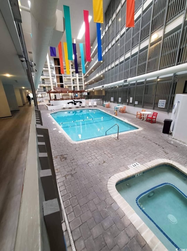 5905 S Kings Hwy Unit 1106, Myrtle Beach, SC 29575 - indoor community pool featuring a community hot tub and a patio area