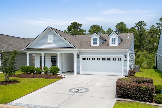 4555 Weekly Dr, Myrtle Beach, SC 29579 - view of front of house featuring a garage, a front lawn, driveway, covered porch, and a shingled roof