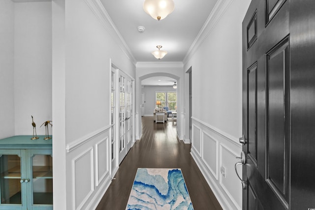 4555 Weekly Dr, Myrtle Beach, SC 29579 - entryway featuring dark wood finished floors, ornamental molding, arched walkways, and wainscoting