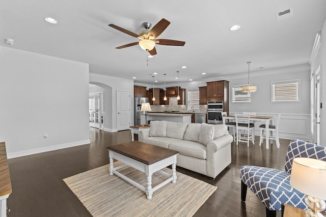 4555 Weekly Dr, Myrtle Beach, SC 29579 - living room featuring ceiling fan, arched walkways, recessed lighting, crown molding, and dark wood finished floors