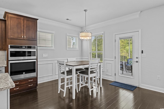 4555 Weekly Dr, Myrtle Beach, SC 29579 - dining room featuring dark wood-type flooring, a wainscoted wall, crown molding, and a decorative wall