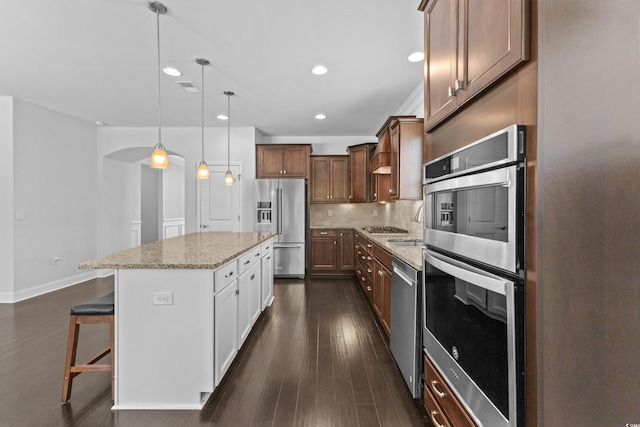 4555 Weekly Dr, Myrtle Beach, SC 29579 - kitchen featuring appliances with stainless steel finishes, tasteful backsplash, light stone counters, a kitchen bar, and a kitchen island