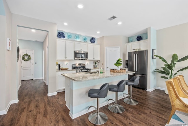 2504 Heritage Loop Unit 2504, Myrtle Beach, SC 29577 - kitchen with stainless steel appliances, a sink, dark wood-style floors, a kitchen island with sink, and recessed lighting