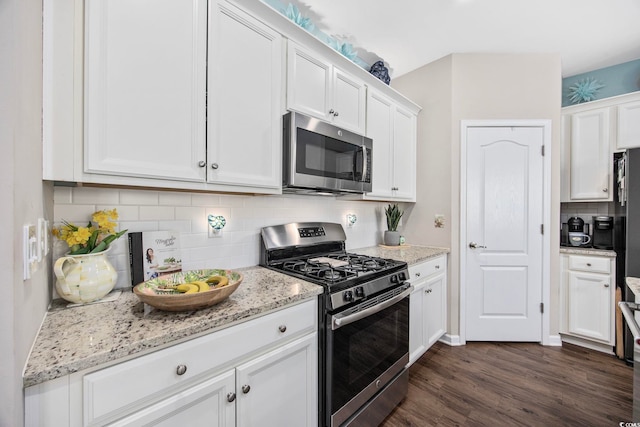 2504 Heritage Loop Unit 2504, Myrtle Beach, SC 29577 - kitchen featuring appliances with stainless steel finishes, white cabinetry, backsplash, and dark wood finished floors