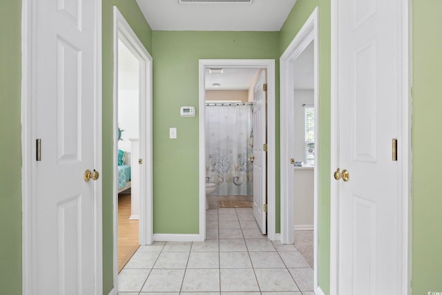 6681 Wisteria Dr, Myrtle Beach, SC 29588 - hallway featuring baseboards and light tile patterned floors