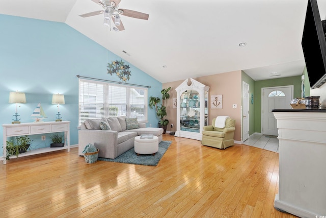 6681 Wisteria Dr, Myrtle Beach, SC 29588 - living room with light wood-style floors, a ceiling fan, high vaulted ceiling, and baseboards