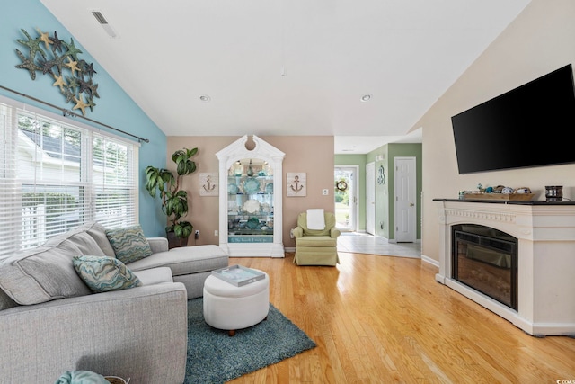 6681 Wisteria Dr, Myrtle Beach, SC 29588 - living room featuring light wood-style flooring, high vaulted ceiling, a glass covered fireplace, recessed lighting, and baseboards