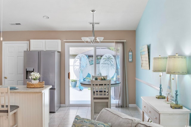 6681 Wisteria Dr, Myrtle Beach, SC 29588 - kitchen featuring stainless steel refrigerator with ice dispenser, pendant lighting, light countertops, a chandelier, and light tile patterned floors