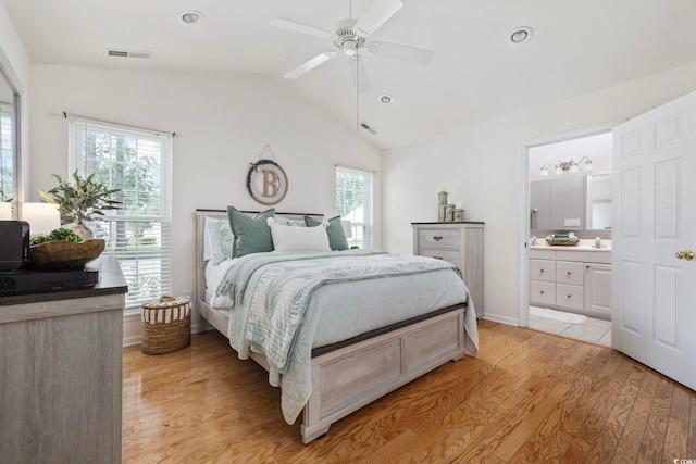 6681 Wisteria Dr, Myrtle Beach, SC 29588 - bedroom with light wood-style flooring, vaulted ceiling, a sink, connected bathroom, and a ceiling fan