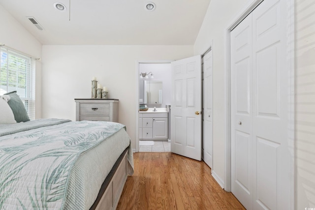6681 Wisteria Dr, Myrtle Beach, SC 29588 - bedroom with light wood finished floors, a closet, connected bathroom, a sink, and recessed lighting