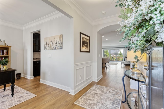 6378 Torino Ln, Myrtle Beach, SC 29572 - hallway featuring arched walkways, light wood-style flooring, ornamental molding, and baseboards