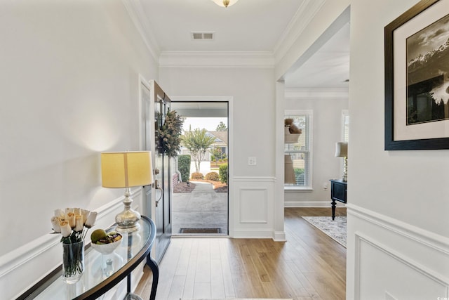 6378 Torino Ln, Myrtle Beach, SC 29572 - entrance foyer with light wood-style flooring, crown molding, and a wainscoted wall