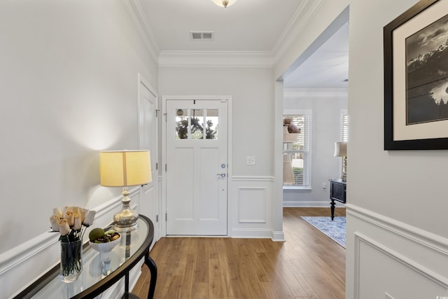 6378 Torino Ln, Myrtle Beach, SC 29572 - entryway featuring light wood-style flooring, plenty of natural light, ornamental molding, and a wainscoted wall