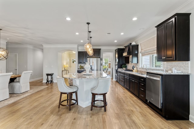 6378 Torino Ln, Myrtle Beach, SC 29572 - kitchen featuring stainless steel appliances, arched walkways, a sink, crown molding, and tasteful backsplash