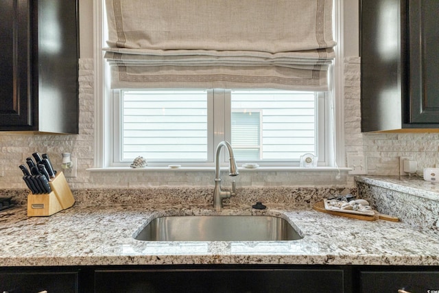 6378 Torino Ln, Myrtle Beach, SC 29572 - kitchen with a sink, decorative backsplash, and light stone countertops