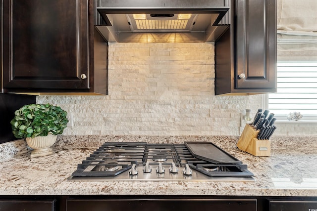 6378 Torino Ln, Myrtle Beach, SC 29572 - kitchen with dark brown cabinets, stainless steel gas stovetop, extractor fan, and tasteful backsplash