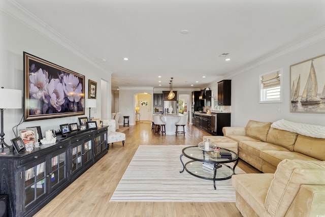 6378 Torino Ln, Myrtle Beach, SC 29572 - living area featuring arched walkways, ornamental molding, light wood-type flooring, and recessed lighting