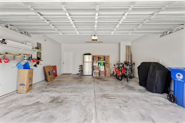 6378 Torino Ln, Myrtle Beach, SC 29572 - garage featuring freestanding refrigerator and a garage door opener