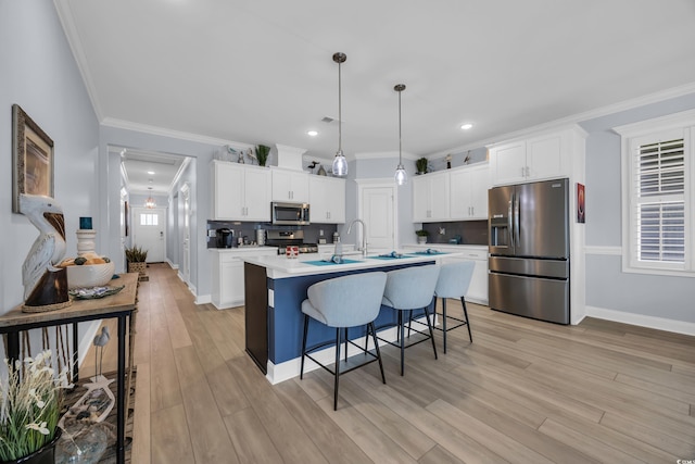 1352 Jolly Roger Dr, North Myrtle Beach, SC 29582 - kitchen featuring stainless steel appliances, white cabinetry, decorative backsplash, a kitchen breakfast bar, and crown molding