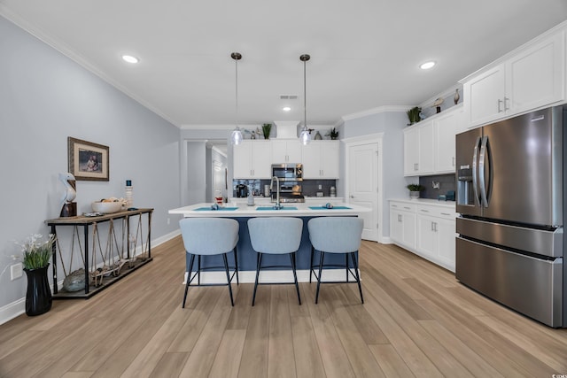 1352 Jolly Roger Dr, North Myrtle Beach, SC 29582 - kitchen featuring appliances with stainless steel finishes, decorative backsplash, a breakfast bar, light countertops, and white cabinetry