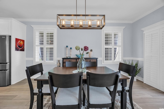 1352 Jolly Roger Dr, North Myrtle Beach, SC 29582 - dining area with a chandelier, plenty of natural light, light wood-type flooring, and ornamental molding