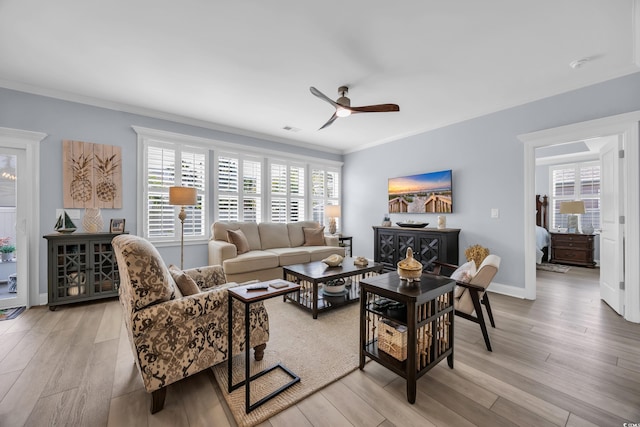 1352 Jolly Roger Dr, North Myrtle Beach, SC 29582 - living room featuring a ceiling fan, ornamental molding, light wood-style floors, and baseboards