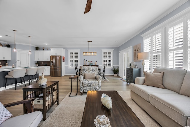 1352 Jolly Roger Dr, North Myrtle Beach, SC 29582 - living room featuring ornamental molding, recessed lighting, light wood-style floors, baseboards, and a chandelier