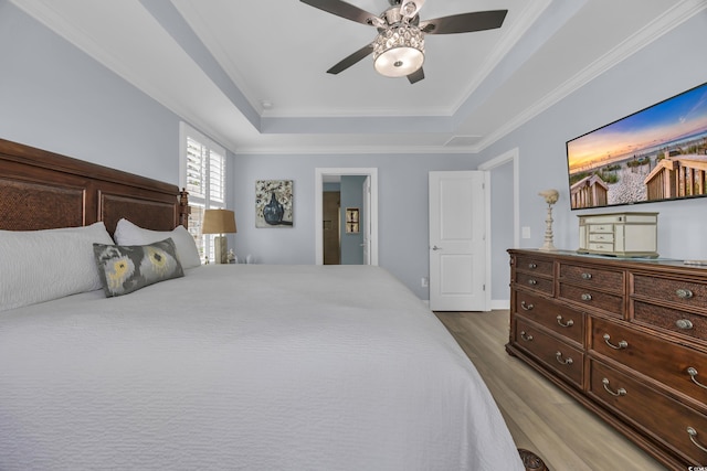 1352 Jolly Roger Dr, North Myrtle Beach, SC 29582 - bedroom featuring a raised ceiling, wood finished floors, ornamental molding, and a ceiling fan