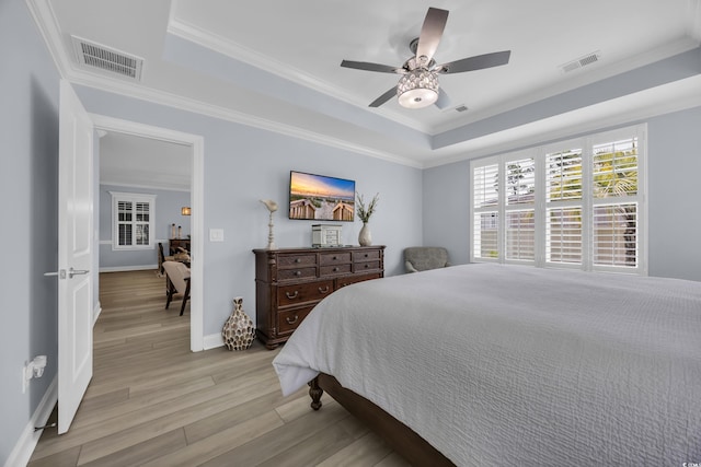 1352 Jolly Roger Dr, North Myrtle Beach, SC 29582 - bedroom with a raised ceiling, light wood-type flooring, crown molding, ceiling fan, and baseboards