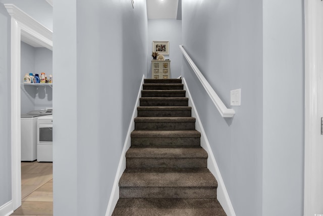 1352 Jolly Roger Dr, North Myrtle Beach, SC 29582 - stairs featuring washing machine and clothes dryer, baseboards, and wood finished floors