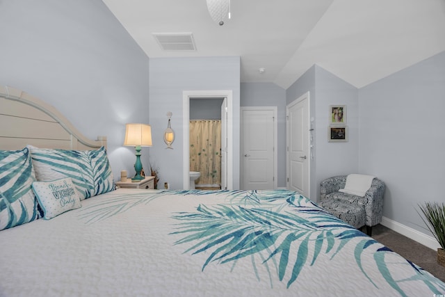 1352 Jolly Roger Dr, North Myrtle Beach, SC 29582 - carpeted bedroom with vaulted ceiling, baseboards, and connected bathroom