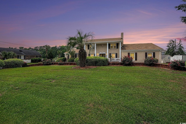 328 Waterside Dr, Myrtle Beach, SC 29577 - greek revival inspired property featuring a lawn, a chimney, a porch, and brick siding