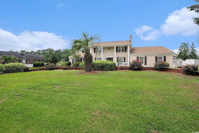 328 Waterside Dr, Myrtle Beach, SC 29577 - view of front of house with a front yard, a chimney, and brick siding